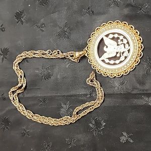 Gold Tone Cut Out Eagle Necklace surrounded by white Rhinestones.